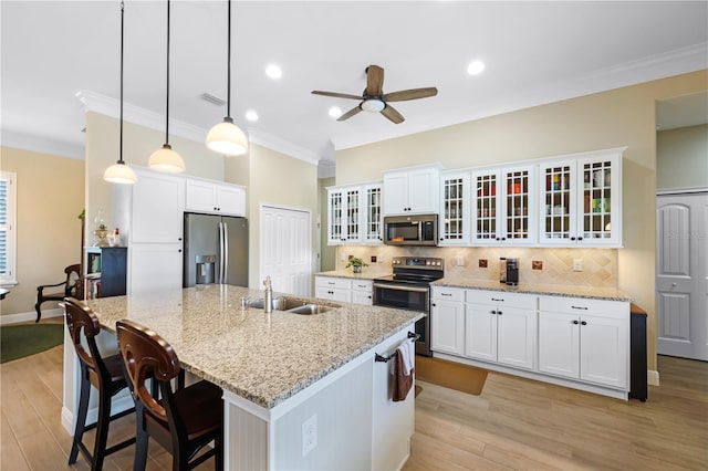 19246 Moore Haven Ct, Port Charlotte, FL 33948 - kitchen featuring stainless steel appliances, a sink, ornamental molding, ceiling fan, and light wood-type flooring