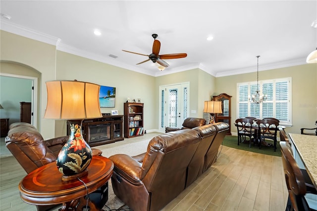 19246 Moore Haven Ct, Port Charlotte, FL 33948 - living room featuring a chandelier, light wood-type flooring, a ceiling fan, crown molding, and baseboards