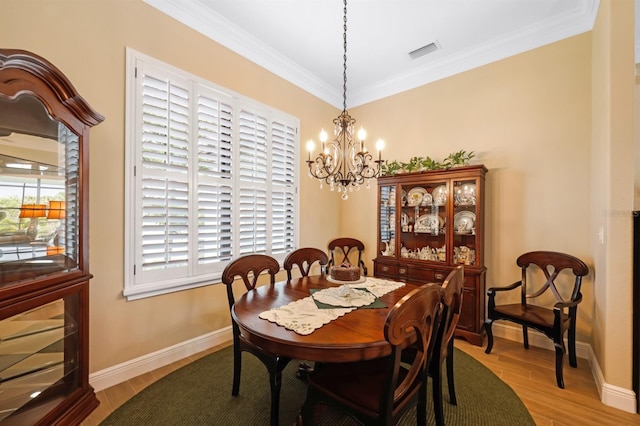 19246 Moore Haven Ct, Port Charlotte, FL 33948 - dining area featuring a chandelier, healthy amount of natural light, ornamental molding, light wood-style flooring, and baseboards