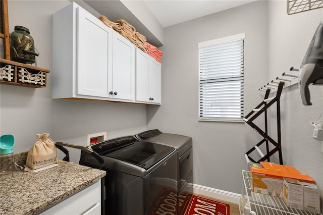 19246 Moore Haven Ct, Port Charlotte, FL 33948 - clothes washing area featuring washing machine and dryer, cabinet space, and baseboards