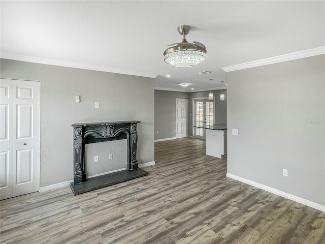 3342 Avanti Cir, North Port, FL 34287 - unfurnished living room featuring ornamental molding, baseboards, wood finished floors, and a fireplace with raised hearth