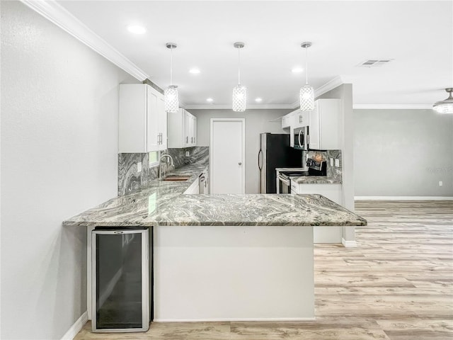 3342 Avanti Cir, North Port, FL 34287 - kitchen with wine cooler, appliances with stainless steel finishes, a sink, light stone countertops, and ornamental molding