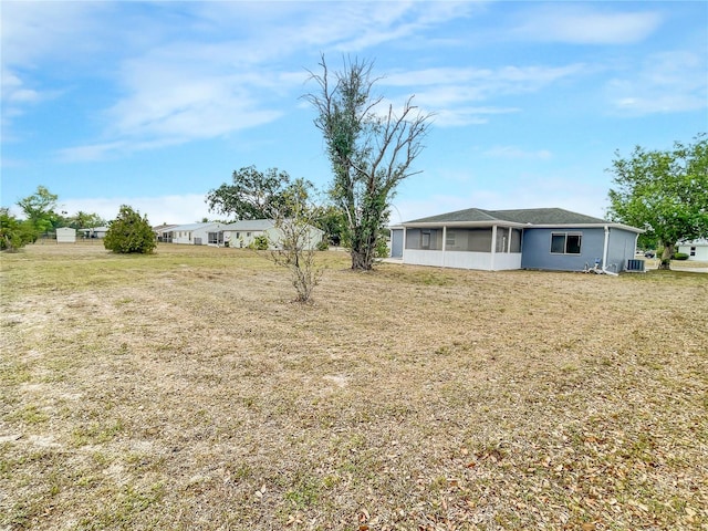 3342 Avanti Cir, North Port, FL 34287 - view of green lawn featuring a sunroom and central AC unit