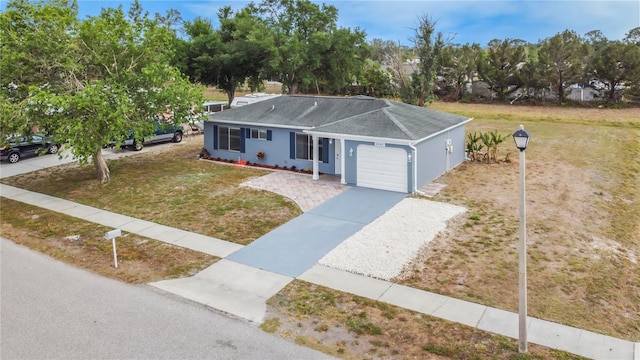 3342 Avanti Cir, North Port, FL 34287 - ranch-style home with a garage, roof with shingles, driveway, a front yard, and stucco siding
