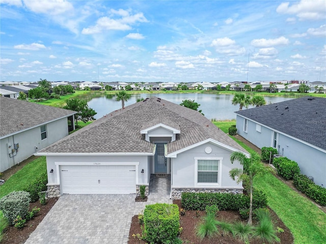 17620 Winding Wood Ln, Punta Gorda, FL 33982 - view of front of home featuring stone siding, a garage, a residential view, stucco siding, and roof with shingles