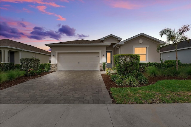 17620 Winding Wood Ln, Punta Gorda, FL 33982 - single story home featuring decorative driveway, stucco siding, and an attached garage