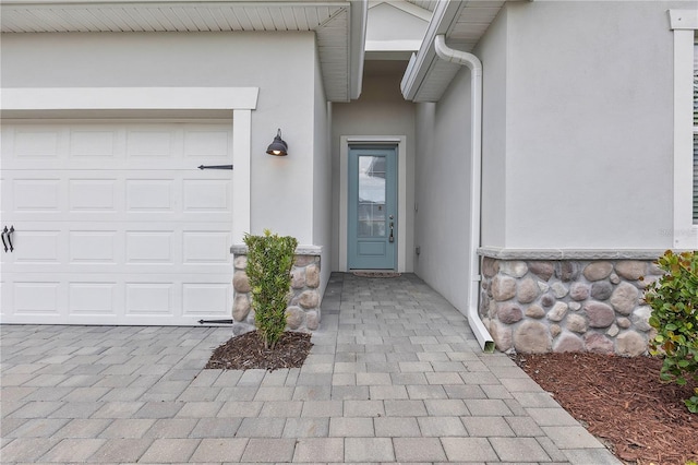 17620 Winding Wood Ln, Punta Gorda, FL 33982 - entrance to property with stucco siding, an attached garage, and stone siding
