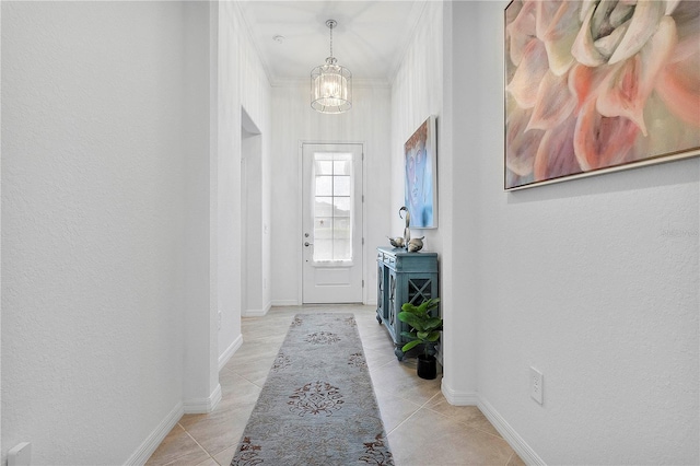 17620 Winding Wood Ln, Punta Gorda, FL 33982 - entryway with a chandelier, light tile patterned floors, baseboards, and crown molding