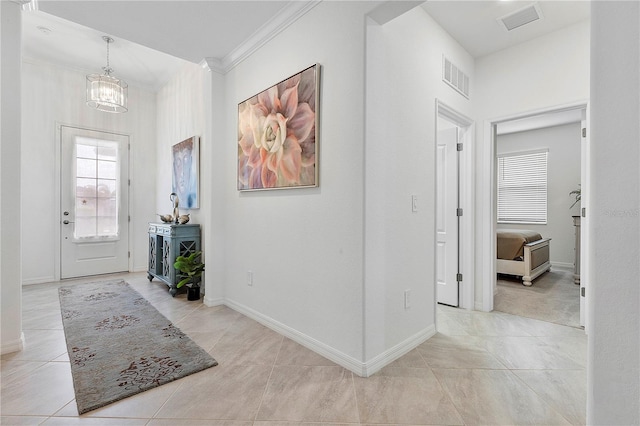 17620 Winding Wood Ln, Punta Gorda, FL 33982 - tiled foyer entrance with a chandelier, ornamental molding, and baseboards