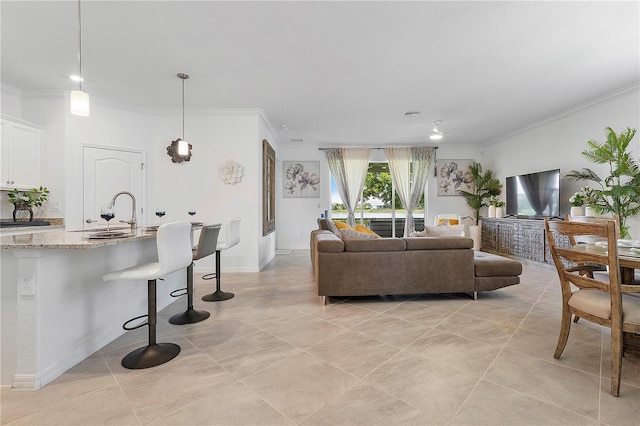 17620 Winding Wood Ln, Punta Gorda, FL 33982 - living room featuring ornamental molding, light tile patterned flooring, and baseboards