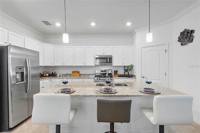 17620 Winding Wood Ln, Punta Gorda, FL 33982 - kitchen with appliances with stainless steel finishes, a sink, ornamental molding, white cabinets, and a breakfast bar
