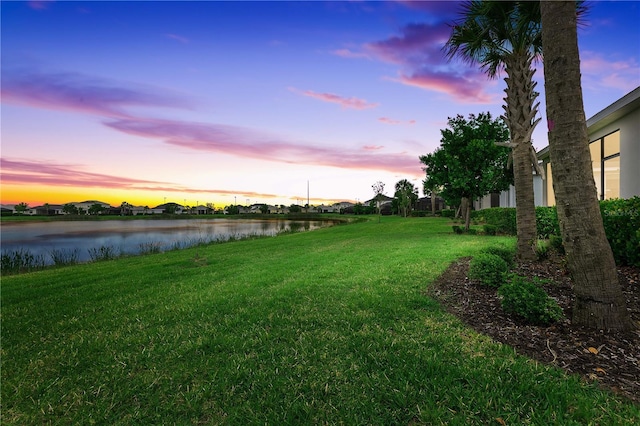 17620 Winding Wood Ln, Punta Gorda, FL 33982 - yard at dusk with a water view and a yard