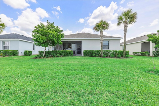 17620 Winding Wood Ln, Punta Gorda, FL 33982 - back of house featuring a lawn and stucco siding