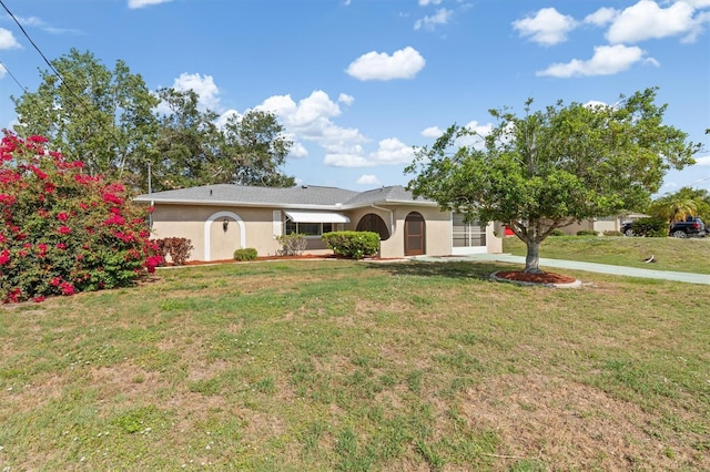485 Dorchester St, Port Charlotte, FL 33954 - ranch-style house with a front lawn and stucco siding