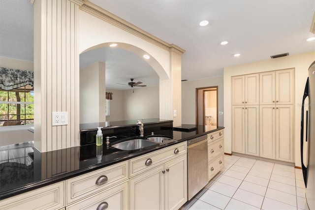 485 Dorchester St, Port Charlotte, FL 33954 - kitchen with cream cabinetry, a sink, dishwasher, a ceiling fan, and arched walkways