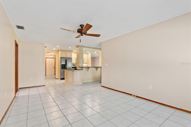 485 Dorchester St, Port Charlotte, FL 33954 - unfurnished living room featuring arched walkways, a ceiling fan, light tile patterned floors, baseboards, and recessed lighting