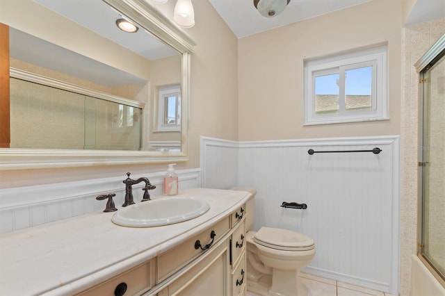 485 Dorchester St, Port Charlotte, FL 33954 - bathroom featuring toilet, a wainscoted wall, vanity, and tile patterned floors