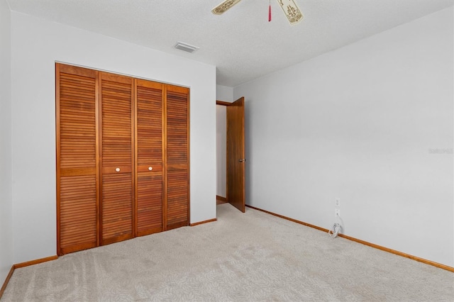 485 Dorchester St, Port Charlotte, FL 33954 - unfurnished bedroom featuring a closet, carpet, baseboards, a ceiling fan, and a textured ceiling