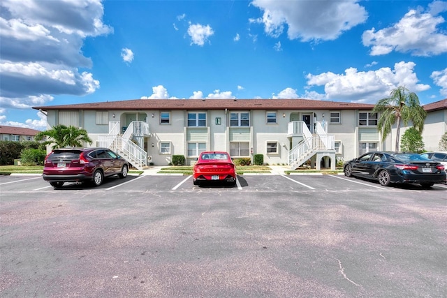 25100 Sandhill Blvd Unit F-203, Punta Gorda, FL 33983 - view of property featuring stairway and uncovered parking