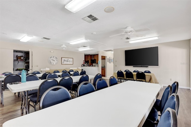 25100 Sandhill Blvd Unit F-203, Punta Gorda, FL 33983 - dining room featuring ceiling fan, attic access, wood finished floors, and a textured ceiling