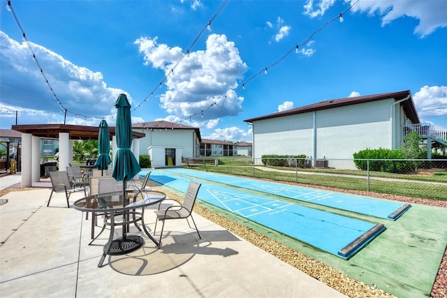 25100 Sandhill Blvd Unit F-203, Punta Gorda, FL 33983 - view of swimming pool with shuffleboard and central air condition unit