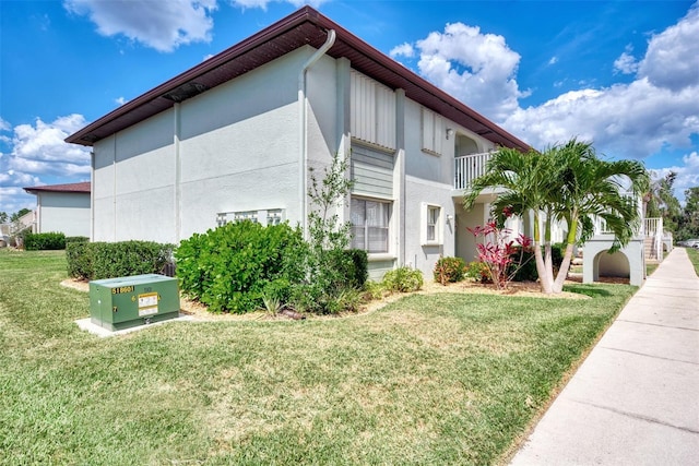 25100 Sandhill Blvd Unit F-203, Punta Gorda, FL 33983 - view of home's exterior with stucco siding and a yard