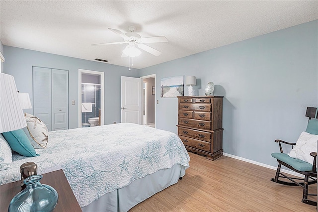 bedroom featuring light wood finished floors, a closet, baseboards, a ceiling fan, and a textured ceiling