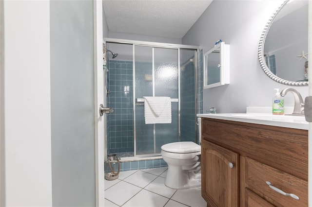 full bathroom with tile patterned floors, a shower stall, toilet, vanity, and a textured ceiling