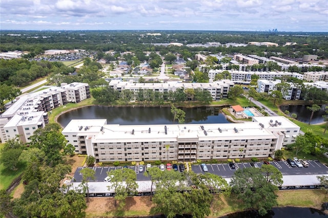 drone / aerial view of apartment complex / building and a nearby body of water