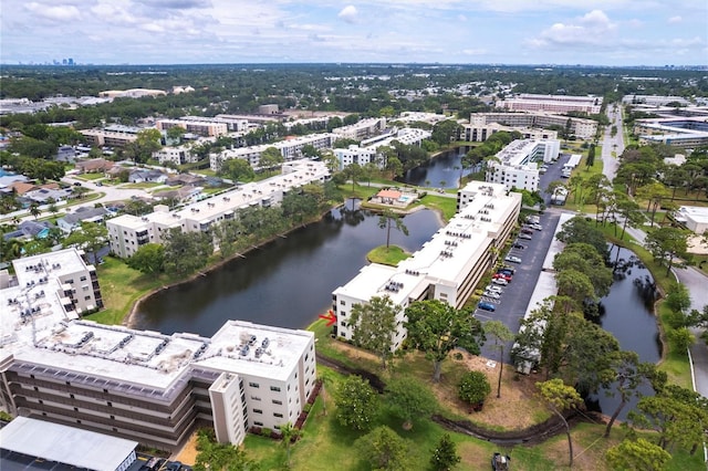 drone / aerial view of a nearby body of water and apartment complex / building