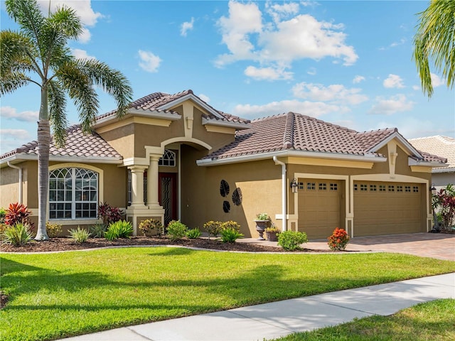 5461 White Ibis Dr, North Port, FL 34287 - mediterranean / spanish home featuring stucco siding, a garage, a front yard, a tile roof, and driveway