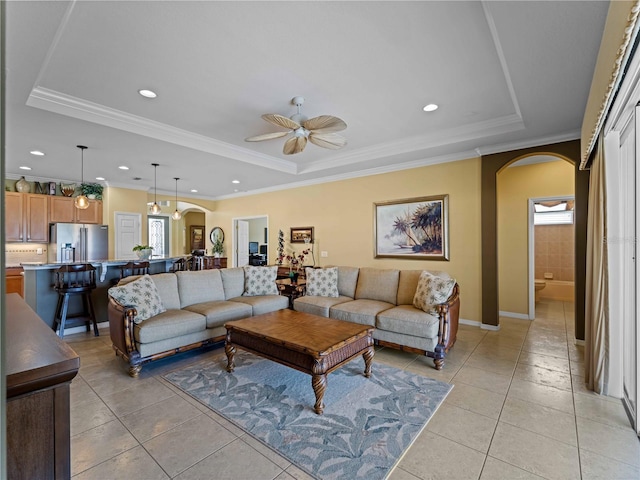 5461 White Ibis Dr, North Port, FL 34287 - living area featuring arched walkways, a tray ceiling, ceiling fan, light tile patterned flooring, and recessed lighting