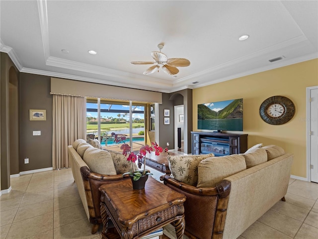 5461 White Ibis Dr, North Port, FL 34287 - living area with a raised ceiling, light tile patterned flooring, a glass covered fireplace, ceiling fan, and baseboards
