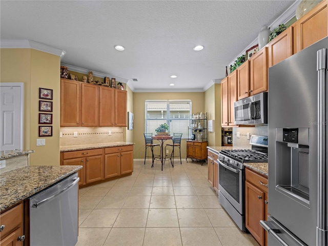 5461 White Ibis Dr, North Port, FL 34287 - kitchen featuring appliances with stainless steel finishes, decorative backsplash, recessed lighting, ornamental molding, and light stone countertops
