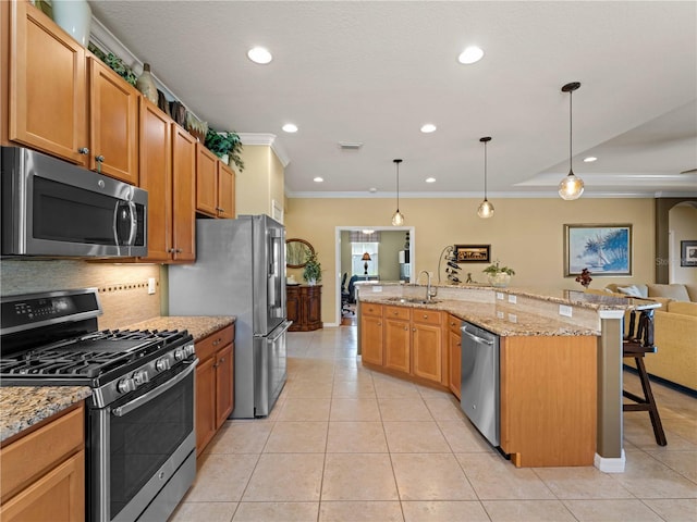5461 White Ibis Dr, North Port, FL 34287 - kitchen with appliances with stainless steel finishes, crown molding, a breakfast bar area, a sink, and light tile patterned floors