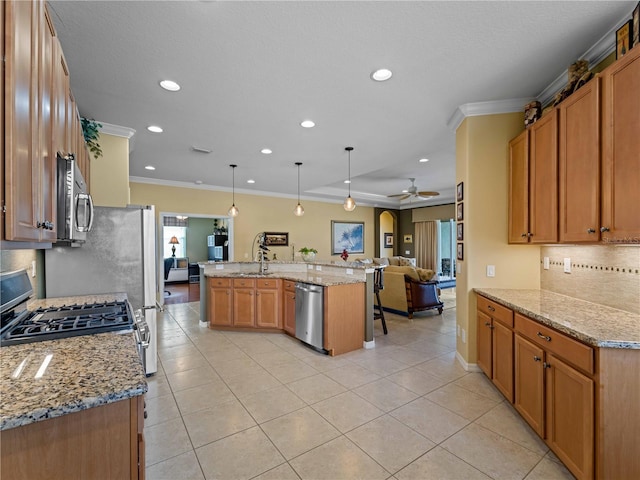 5461 White Ibis Dr, North Port, FL 34287 - kitchen with stainless steel appliances, crown molding, backsplash, open floor plan, and ceiling fan