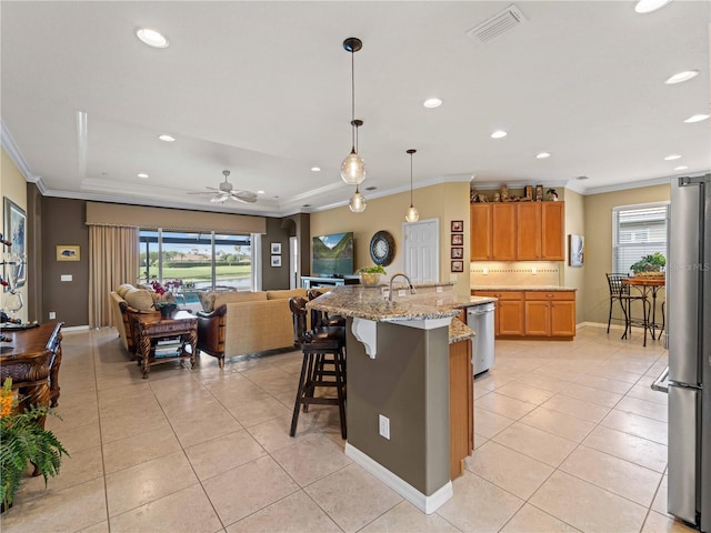5461 White Ibis Dr, North Port, FL 34287 - kitchen with stainless steel appliances, ornamental molding, light tile patterned floors, a sink, and open floor plan