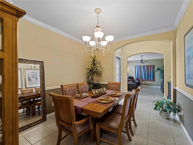 5461 White Ibis Dr, North Port, FL 34287 - dining area with arched walkways, crown molding, light tile patterned flooring, a chandelier, and baseboards