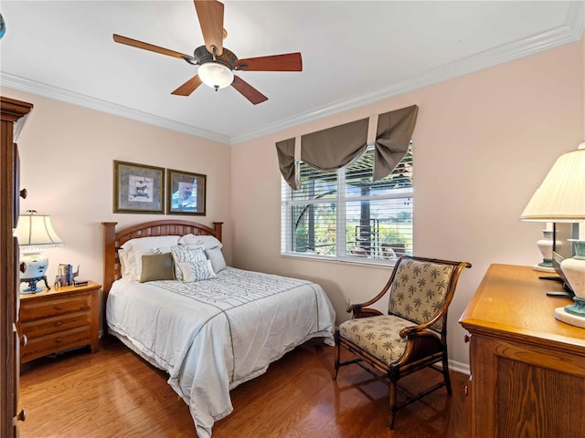 5461 White Ibis Dr, North Port, FL 34287 - bedroom with crown molding, wood finished floors, a ceiling fan, and baseboards