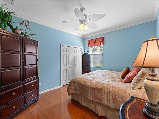 5461 White Ibis Dr, North Port, FL 34287 - bedroom with wood finished floors, a closet, ornamental molding, a ceiling fan, and baseboards