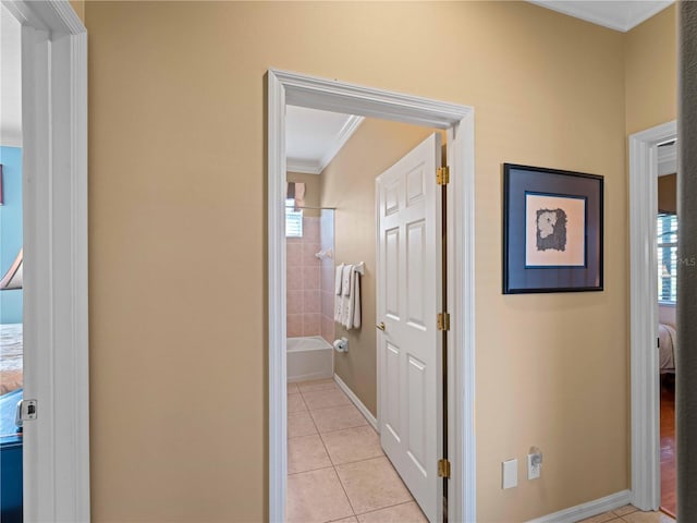5461 White Ibis Dr, North Port, FL 34287 - hall with light tile patterned floors, ornamental molding, and baseboards