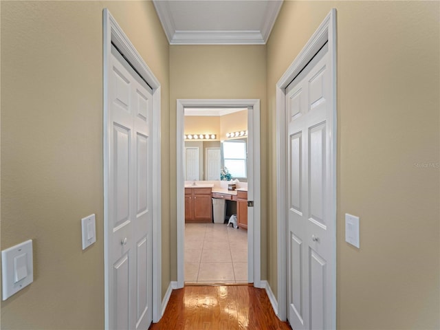 5461 White Ibis Dr, North Port, FL 34287 - hallway with crown molding, light wood finished floors, and baseboards