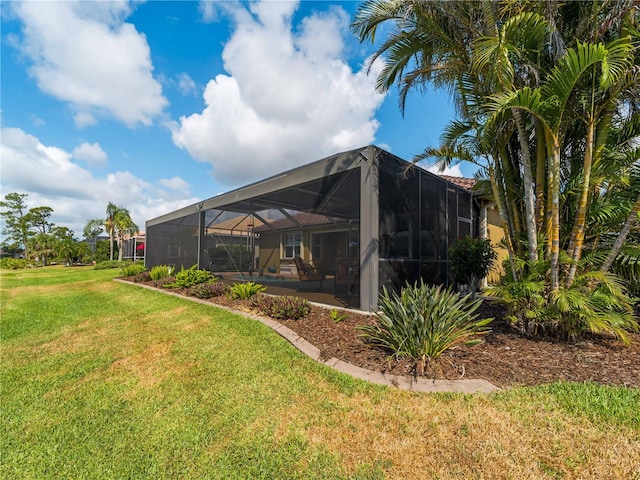 5461 White Ibis Dr, North Port, FL 34287 - rear view of property featuring a lawn and glass enclosure