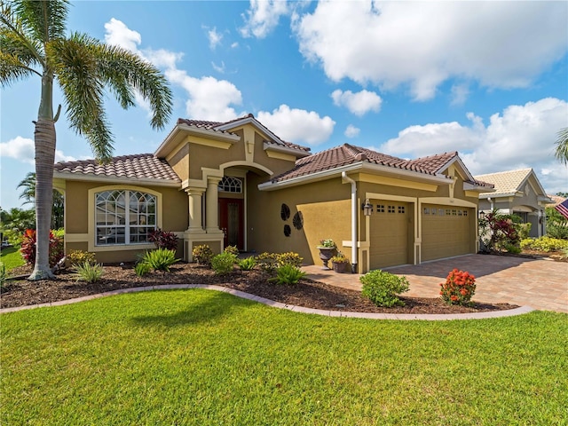5461 White Ibis Dr, North Port, FL 34287 - mediterranean / spanish-style home featuring stucco siding, an attached garage, a front yard, and a tile roof