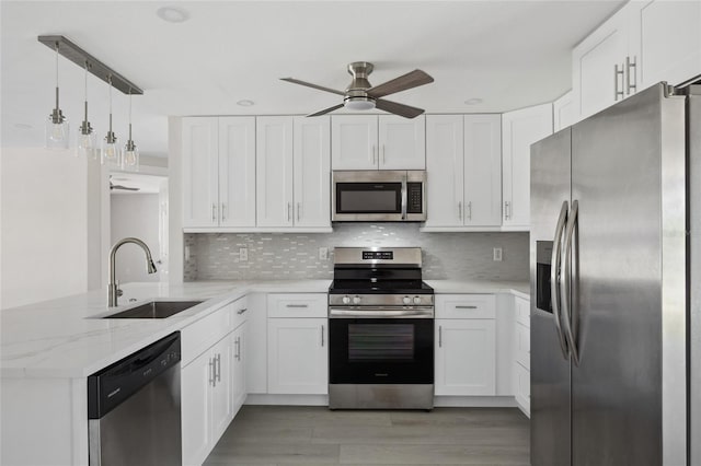 10517 Greenway Ave, Englewood, FL 34224 - kitchen featuring appliances with stainless steel finishes, a sink, a ceiling fan, and white cabinets