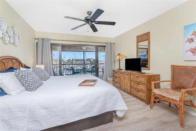 3160 Matecumbe Key Rd Unit 238, Punta Gorda, FL 33955 - bedroom with access to outside, light wood-type flooring, a ceiling fan, and a textured ceiling