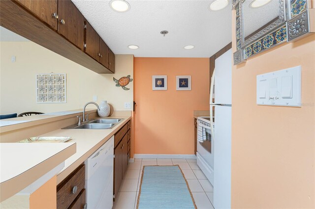 3160 Matecumbe Key Rd Unit 238, Punta Gorda, FL 33955 - kitchen with a sink, white appliances, light countertops, light tile patterned floors, and a textured ceiling