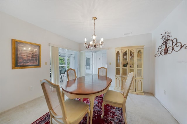 2193 Beacon Dr, Port Charlotte, FL 33952 - dining room with light colored carpet and a chandelier