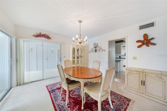 2193 Beacon Dr, Port Charlotte, FL 33952 - dining space featuring light carpet and a chandelier