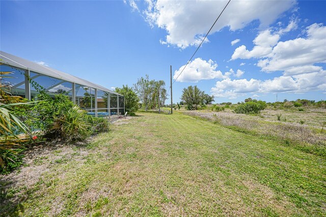 2193 Beacon Dr, Port Charlotte, FL 33952 - view of green lawn featuring a lanai